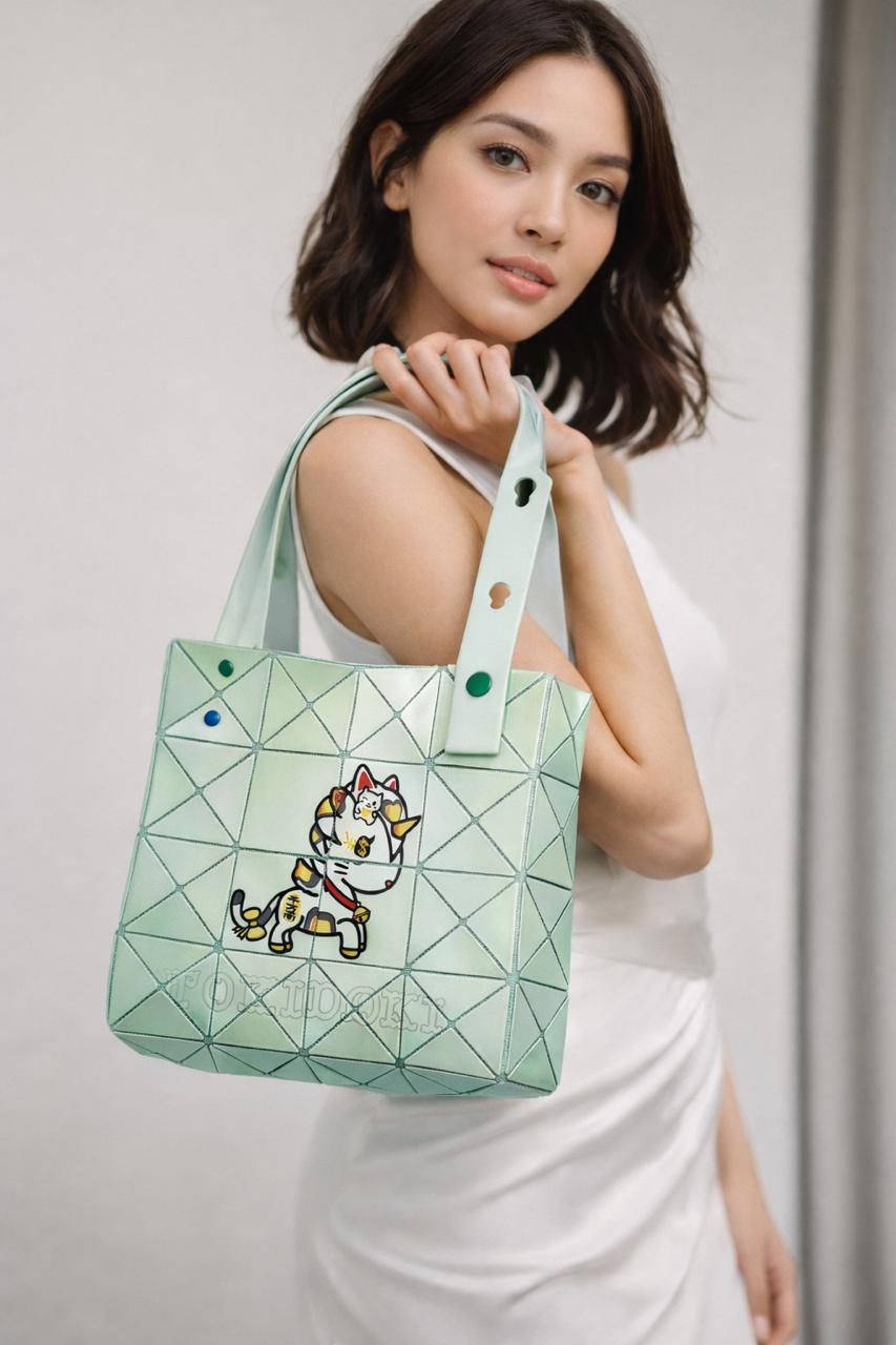 Woman holding a green geometric handbag with a cat design.