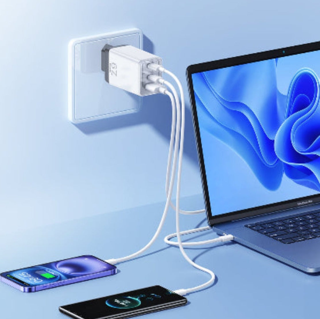 Laptop, smartphone, and tablet charging from a single power adapter on a light blue background